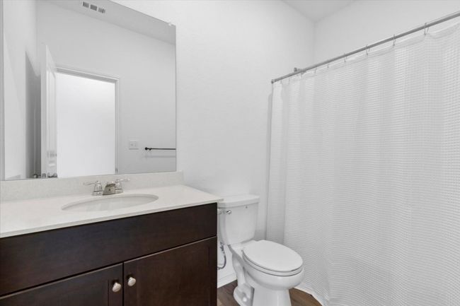 Full bathroom featuring vanity, wood finished floors, and a shower with curtain | Image 14