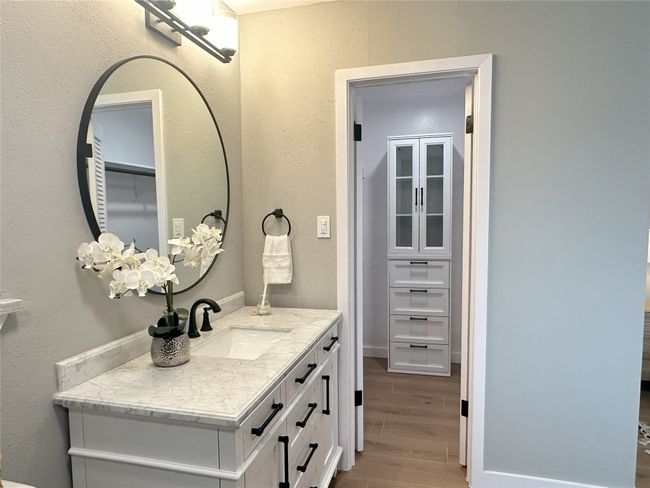 Bathroom featuring hard tile floors and vanity | Image 14