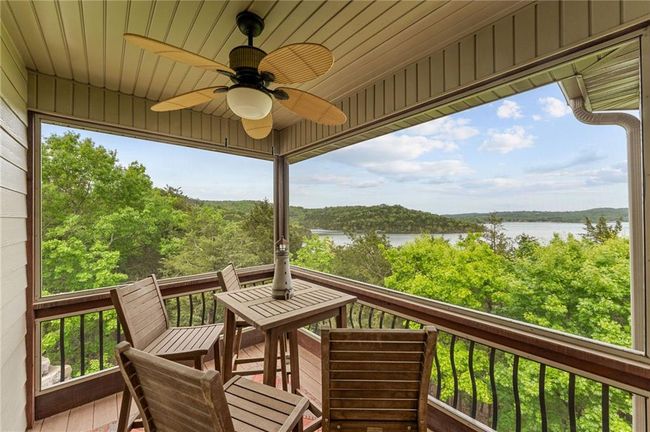 Wooden terrace with a water view and ceiling fan | Image 24