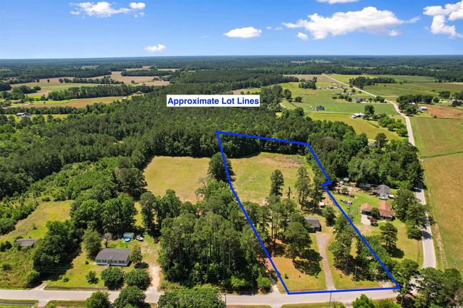 View of rural area with property parcel outlined and a heavily wooded area | Image 8