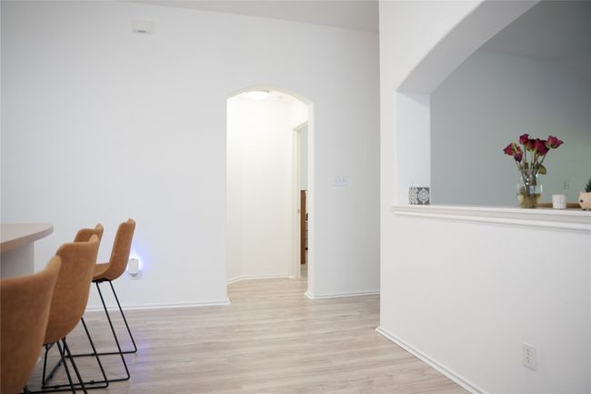 Corridor featuring arched walkways, light wood-type flooring, and baseboards | Image 13