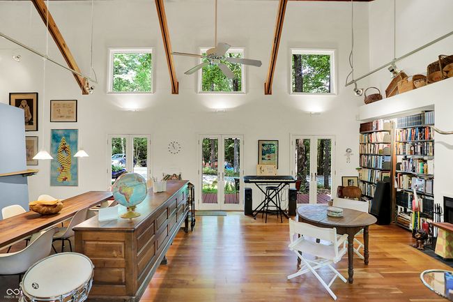 living room featuring french doors, ceiling fan, a high ceiling, plenty of natural light, and wood finished floors | Image 6