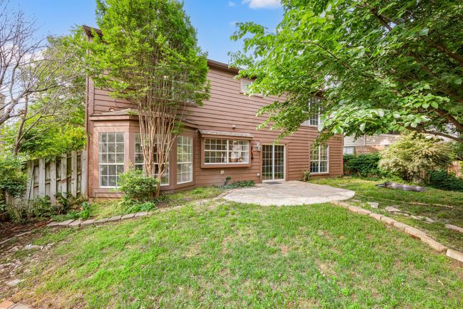 The fenced-in backyard offers a private, lush environment ideal for entertaining or relaxing. | Image 36