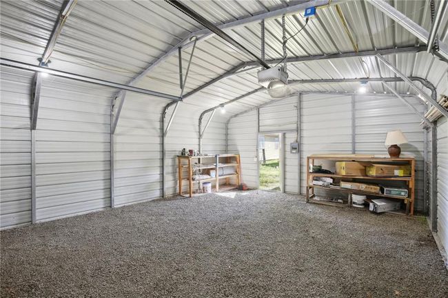 Garage featuring a garage door opener and metal wall | Image 24