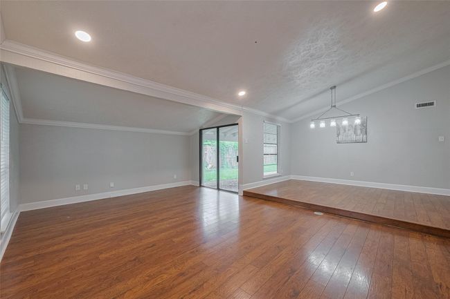 Upon entering you'll find high ceilings, formal living area, and dining space with updated light fixture and sliding doors to the backyard | Image 4