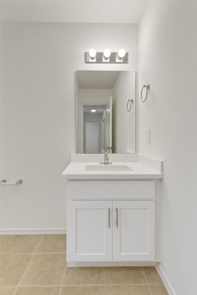 Bathroom with vanity, baseboards, and tile patterned floors | Image 19