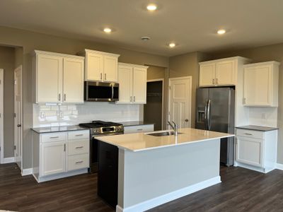 (*Photo of another Glacier plan home, actual homes finishes will vary) Open and inviting throughout, the stunning kitchen will be the focal point of gatherings for years to come. Imagine entertaining friends and family in this open space! | Image 3