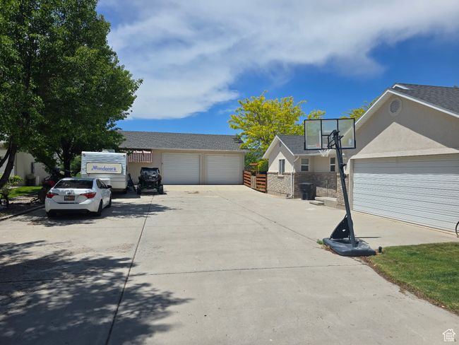 View of property exterior with stucco siding and a garage | Image 55