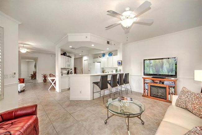 Living room featuring crown molding, recessed lighting, light tile patterned floors, visible vents, and ceiling fan | Image 7