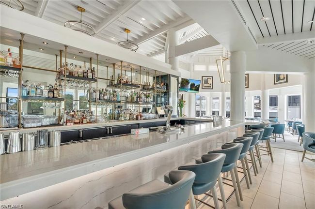 Bar with tile patterned flooring, wet bar, and a towering ceiling | Image 30