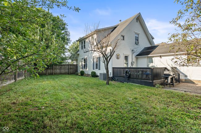 back of house with a fenced backyard and a wooden deck | Image 55