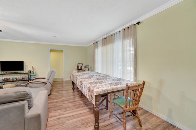 Dining room featuring wood finished floors, baseboards, and ornamental molding | Image 22