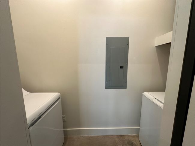 Laundry area with electric panel and baseboards | Image 21