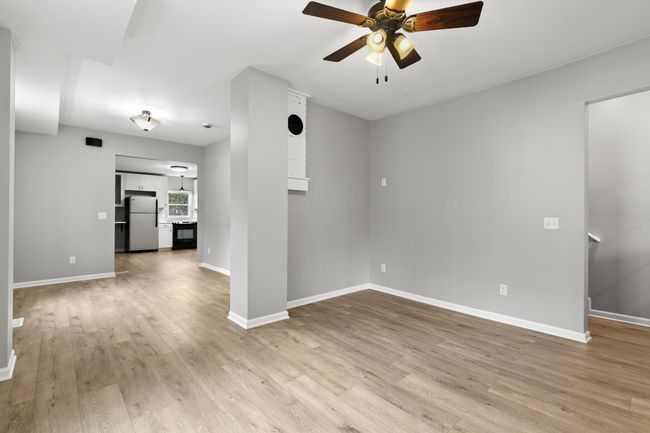 A view from the living room looking back towards the dining room and kitchen. | Image 12