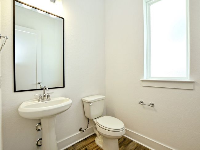 Bathroom featuring baseboards and wood finished floors | Image 25