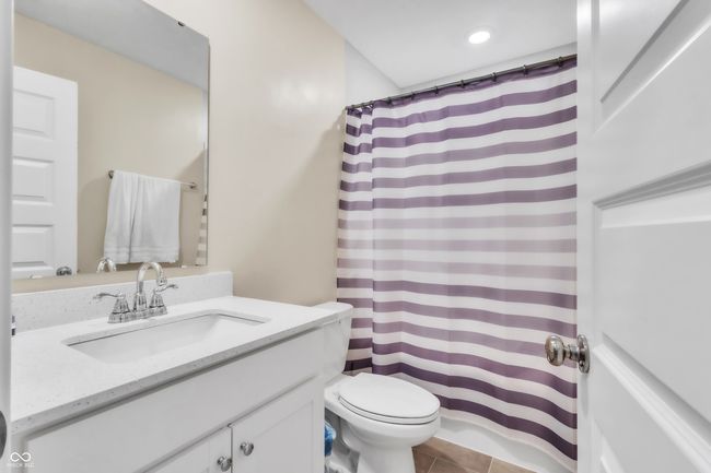 full bath with tile patterned floors, vanity, a shower with curtain, and toilet | Image 13