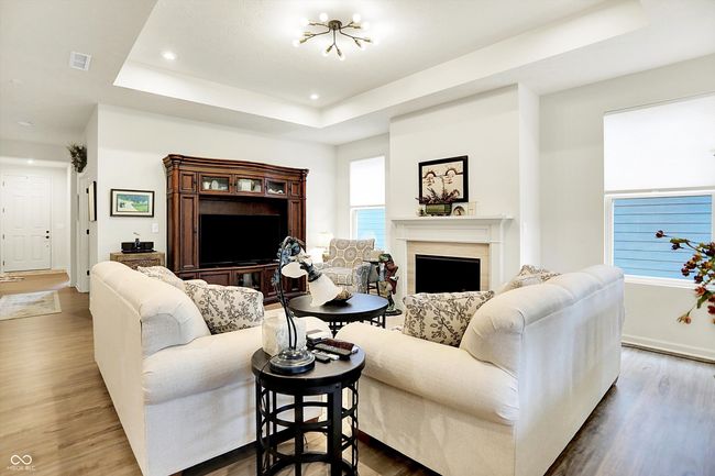 Family room open to kitchen & dining. Luxury vinyl plank throughout with elegant lighting | Image 4