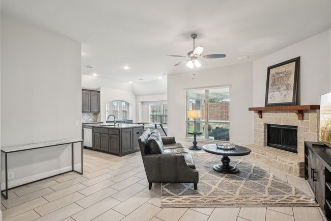 Living room featuring a ceiling fan, a fireplace, and recessed lighting. View of big covered patio | Image 15