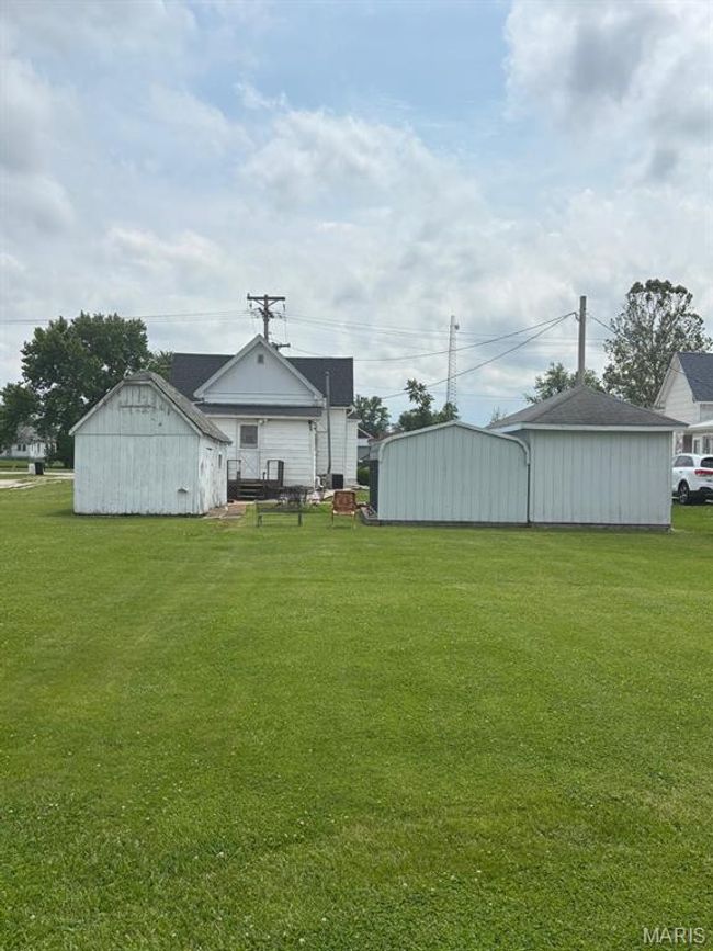 View of grassy yard with an outdoor structure and a pole building | Image 10
