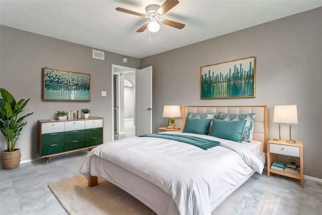Another view of the bedroom reveals its functional layout with plenty of space for furniture and storage. The clean lines and soft color palette create a calming atmosphere, ideal for unwinding at the end of the day. | Image 16