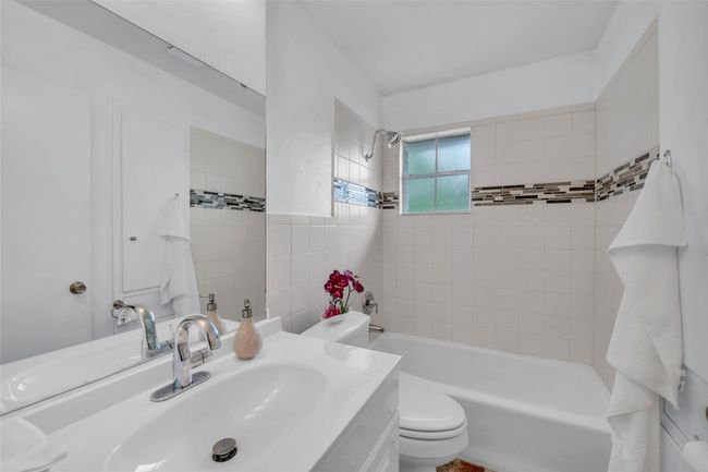 Full bathroom featuring vanity, toilet, and shower combination | Image 13