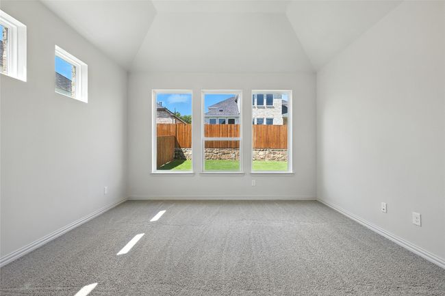 Unfurnished room featuring carpet floors and vaulted ceiling | Image 17
