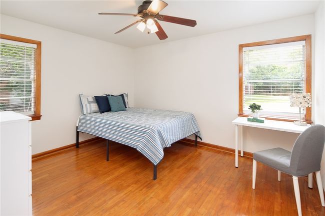 Bedroom with multiple windows, light wood-style floors, and baseboards | Image 14