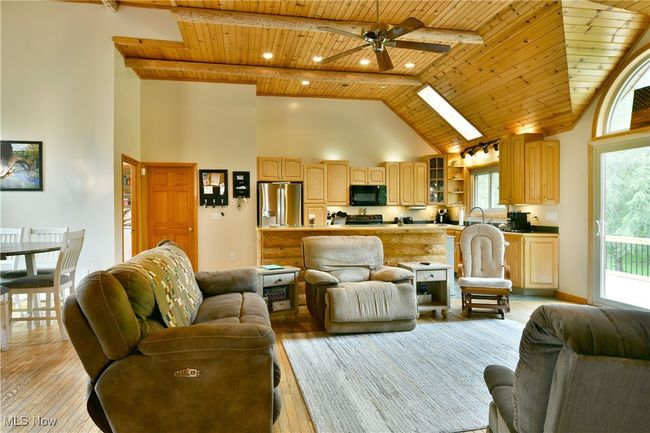 Living area featuring wood ceiling, high vaulted ceiling, light wood-style floors, a ceiling fan, and recessed lighting | Image 8