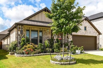 View of front facade with a garage and a front lawn | Image 3