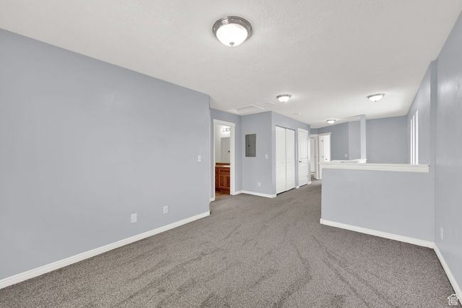 Carpeted spare room with baseboards and electric panel | Image 17