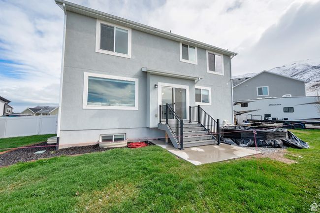 Rear view of property with a lawn, fence, and stucco siding | Image 27