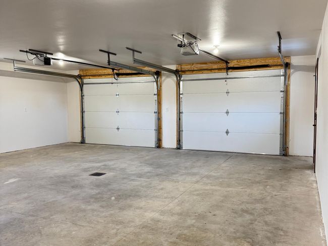 Two single overhead doors help reduce heat loss in wintertime. | Image 24