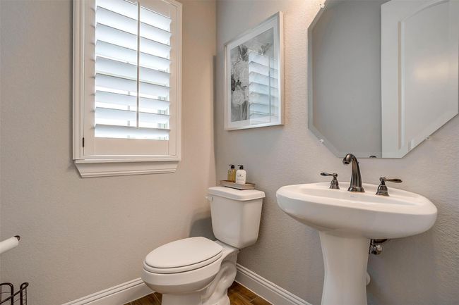 Half bath featuring toilet and wood finished floors | Image 32