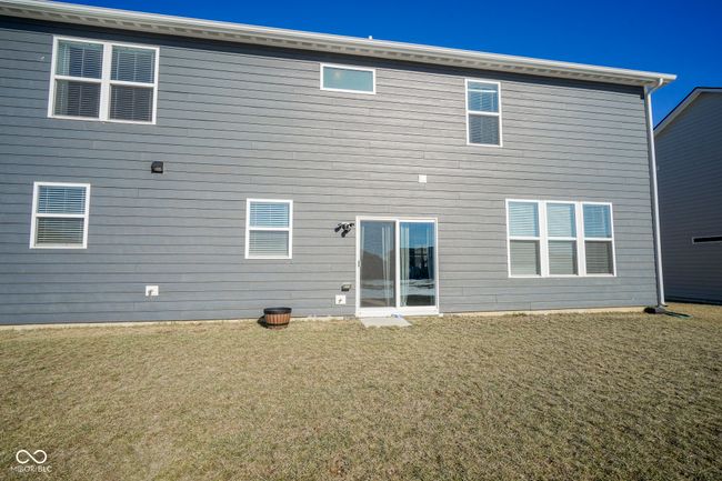 rear view of property with a lawn | Image 44