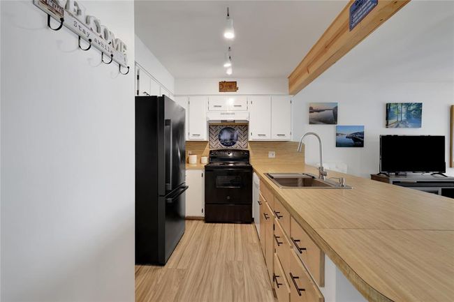 The breakfast bar has drawers, cabinets and provides additional prep space | Image 11