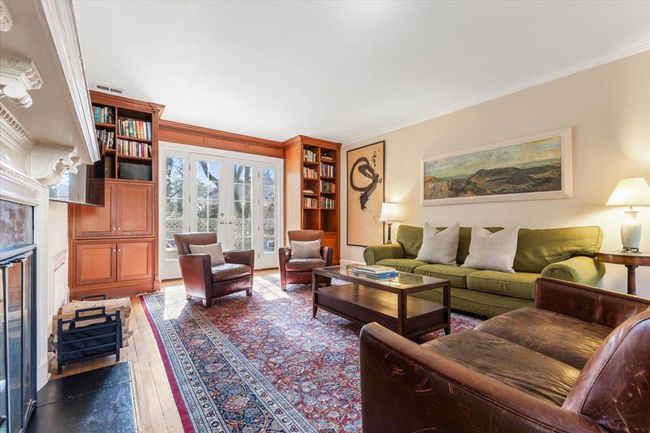 Living room with french doors, ornamental molding, dark wood-style flooring, and visible vents | Image 6