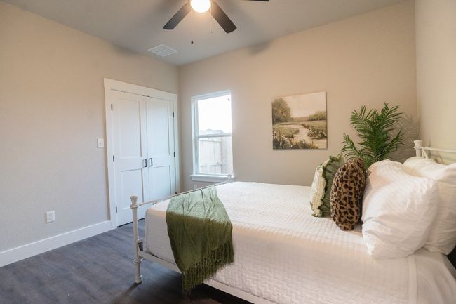 Bedroom featuring dark wood-style flooring, baseboards, ceiling fan, and a closet | Image 18