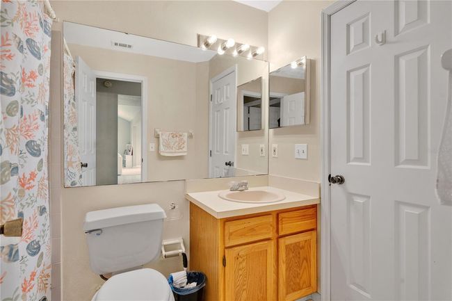 Attached guest bath with entrance into bedroom 2 and hallway | Image 15