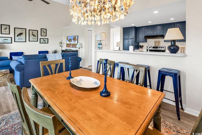 Dining space with recessed lighting, baseboards, ceiling fan with notable chandelier, and wood finished floors | Image 9