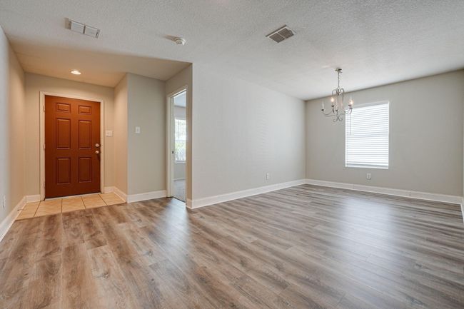 Entryway with wood finished floors, a chandelier, healthy amount of natural light, a textured ceiling, and recessed lighting | Image 5