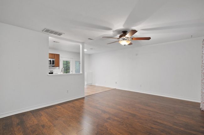 Unfurnished room with ceiling fan and wood finished floors | Image 7