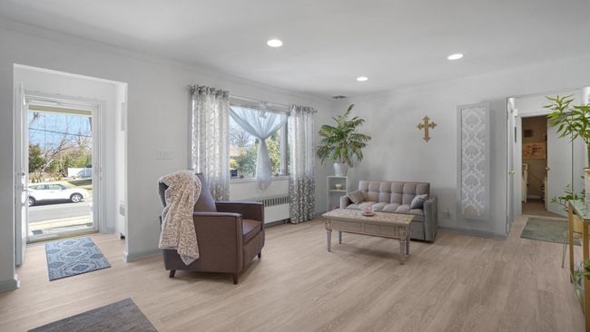 Living room featuring recessed lighting, light wood-type flooring, and radiator | Image 4