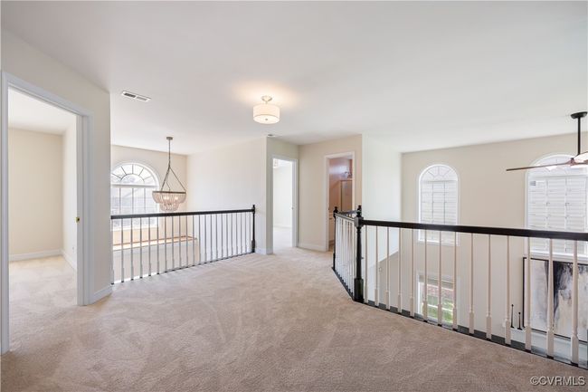 Upstairs, the bedrooms and baths circle like the spokes of a wagon wheel around the spacious upper Foyer. | Image 24