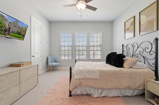 Bedroom featuring carpet flooring, multiple windows, and ceiling fan | Image 18