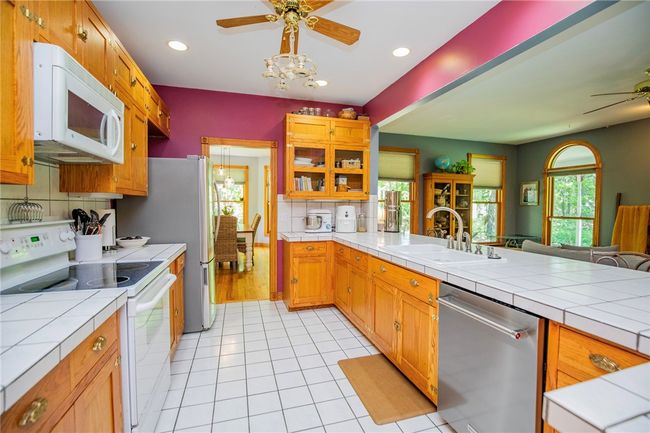 A recipe for success in this comfortable farm style kitchen with convenience, custom wood cabinets galore and even more! | Image 14