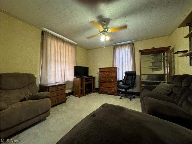 Carpeted living room featuring ceiling fan | Image 6