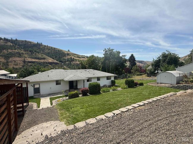 Back of property with a shed, a mountain view, and a patio | Image 7