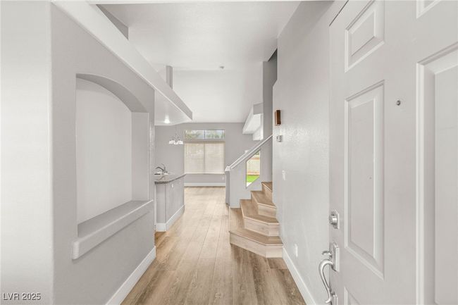 Foyer featuring baseboards, stairs, and light wood finished floors | Image 7