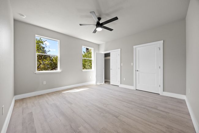 Unfurnished bedroom with baseboards, a ceiling fan, and wood finished floors | Image 21