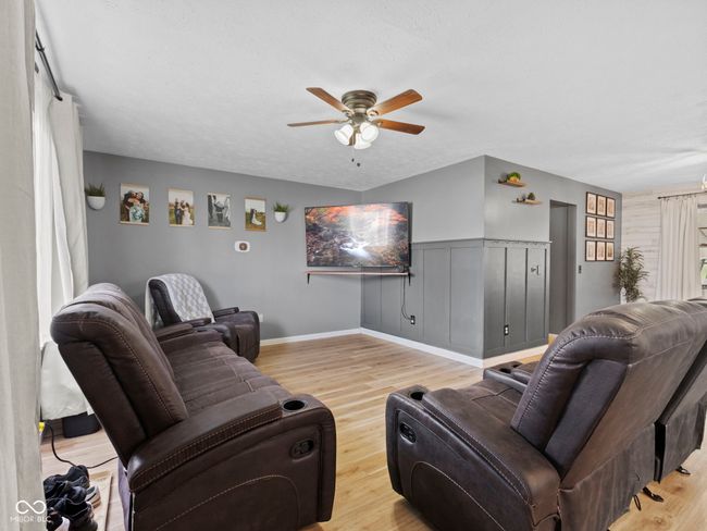 living room featuring ceiling fan and wood finished floors | Image 4